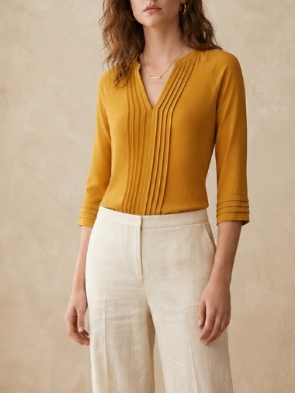 Gold/mustard colored pleated front blouse
